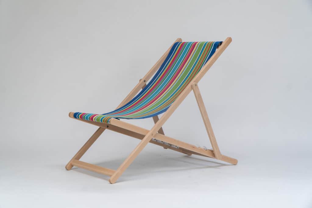 Beechwood Deckchair with Climbing Fabric - blue, green, yellow, red and pink stripes, viewed at an angle - created by Decks and Stipes Ireland