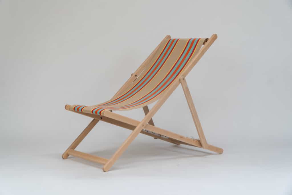 Beechwood Deckchair with Dice Fabric, fawn, terracotta, turquoise, red, and yellow stripes, viewed at an angle - created by Decks and Stipes Ireland