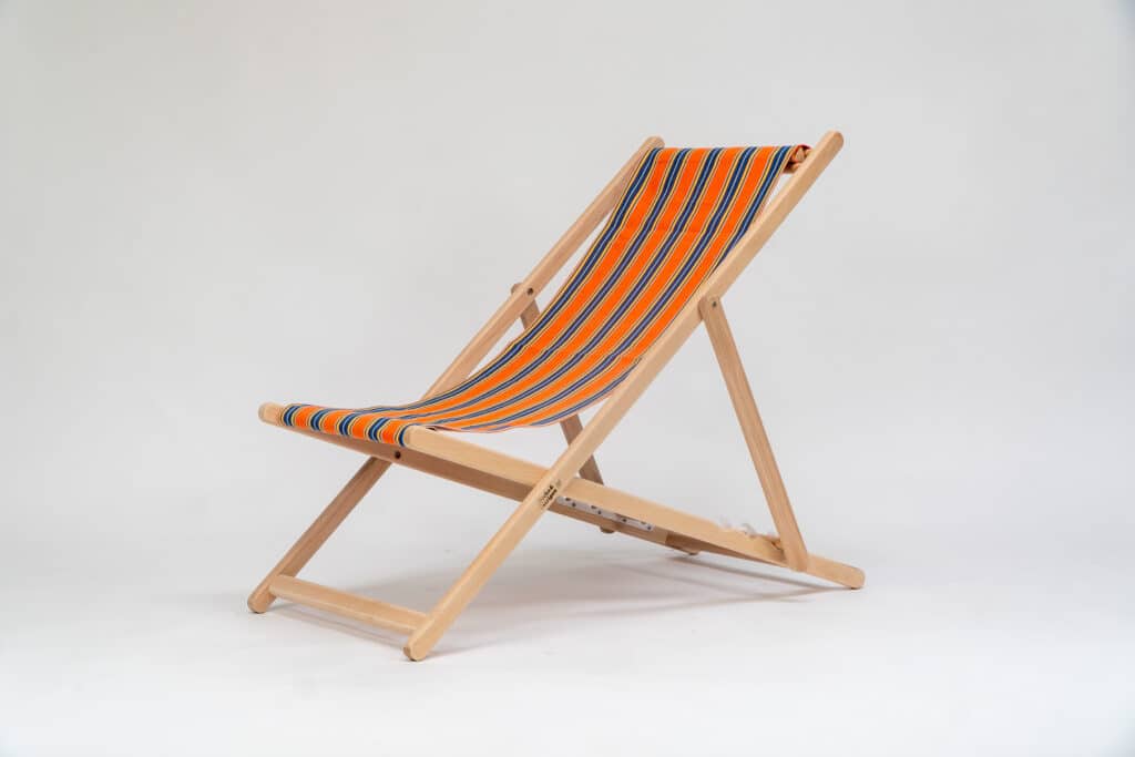 Beechwood Deckchair with Jazz fabric, rust, blue, yellow, white and black stripes, viewed from an angle - created by Decks and Stipes Ireland