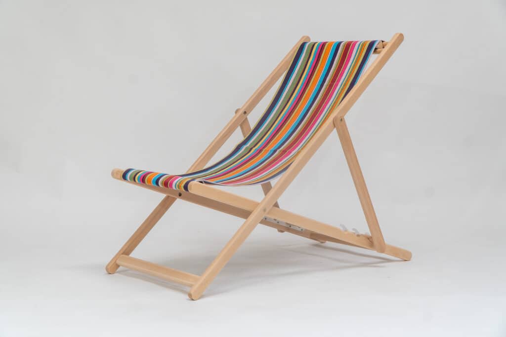 Beechwood Deckchair with Paintballing fabric, blue, green, orange, yellow pink and red stripes, viewed from an angle - created by Decks and Stipes Ireland