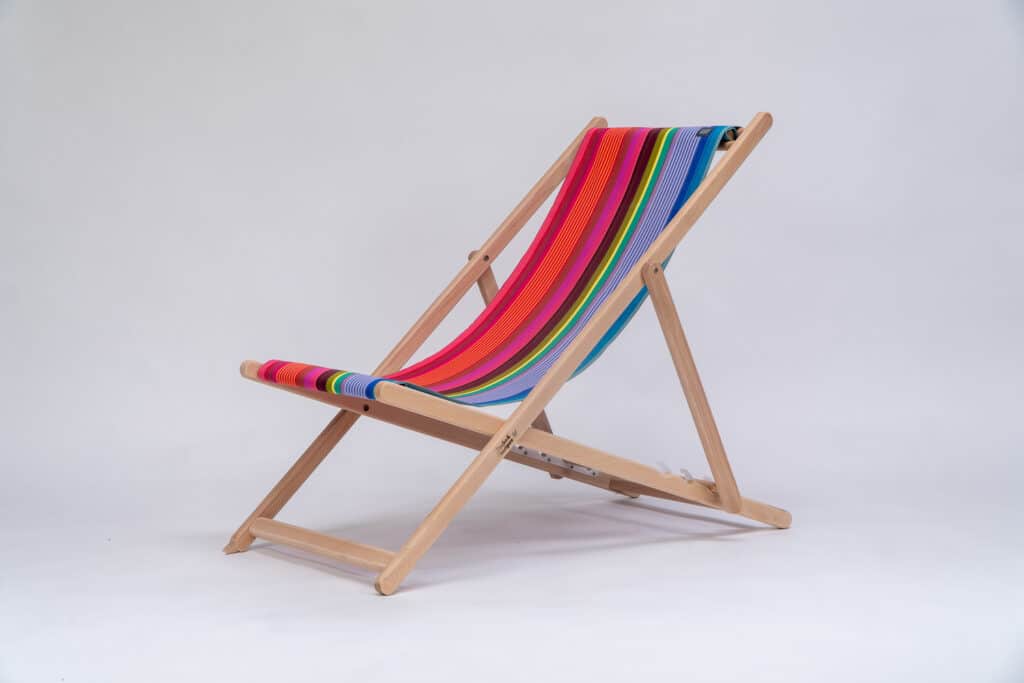 Beechwood Deckchair with Saint-Jean Surfing fabric, purple, green, blue, navy, yellow and orange stripes, viewed from an angle - created by Decks and Stipes Ireland