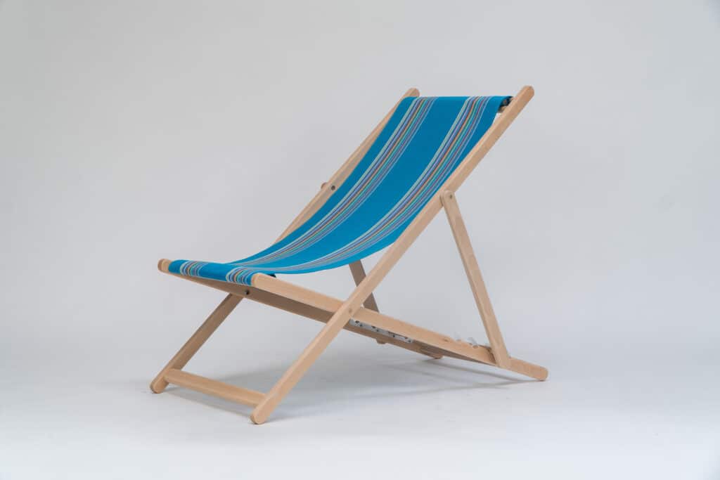 Beechwood Deckchair with Swimming fabric, blue, yellow, pink, orange, purple and green stripes, viewed from an angle - created by Decks and Stipes Ireland