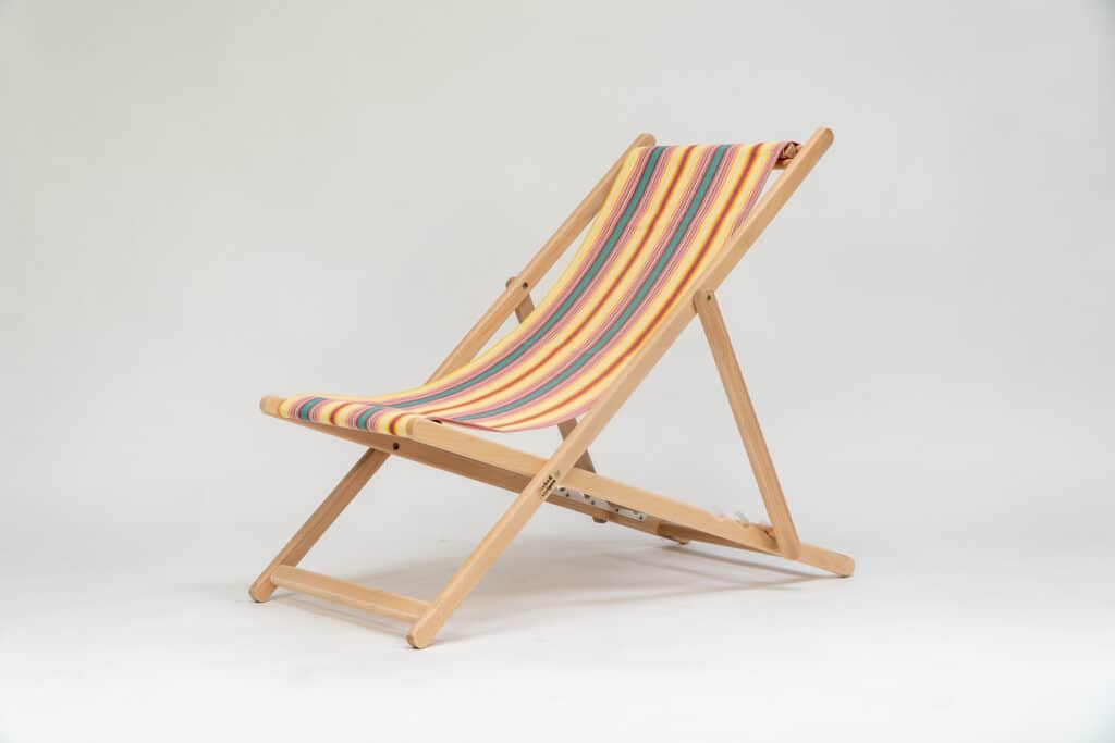 Beechwood Deckchair with Waltzing fabric, yellow, pink, green, lavendar and white stripes, viewed from at an angle - created by Decks and Stipes Ireland